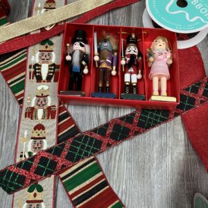 Flat lay of Nutcracker-themed wired ribbons and coordinating Nutcracker ornaments for Christmas crafting.