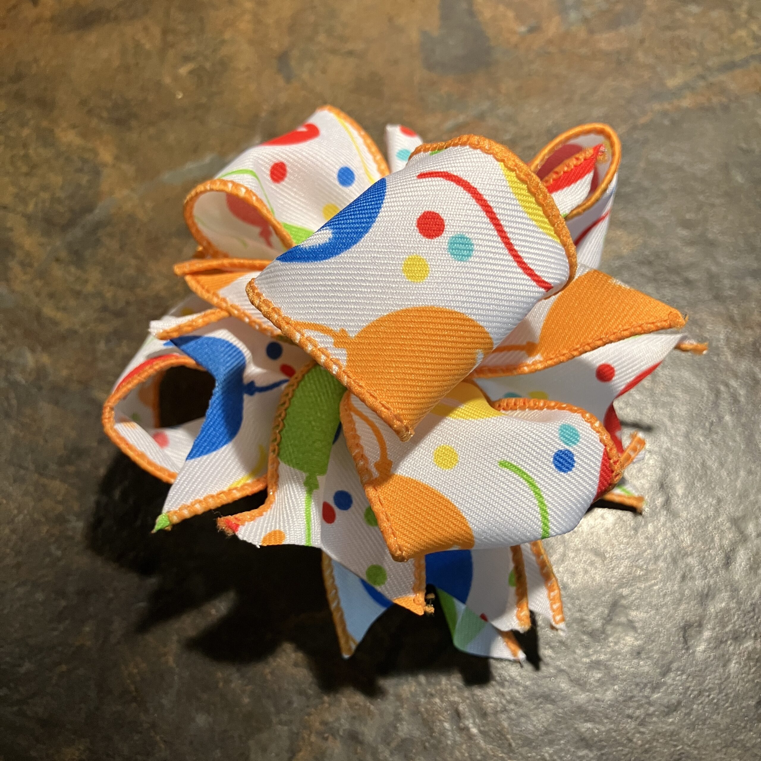 Beginner bow tutorial featuring a colorful wired ribbon bow made with 1.5-inch ribbon.
